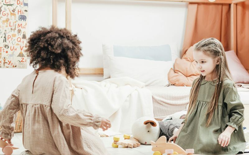 Montessori nanny with child learning materials